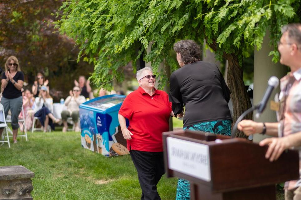 Angie Sheets shakes hands with Kim Cassidy at the Staff Picnic