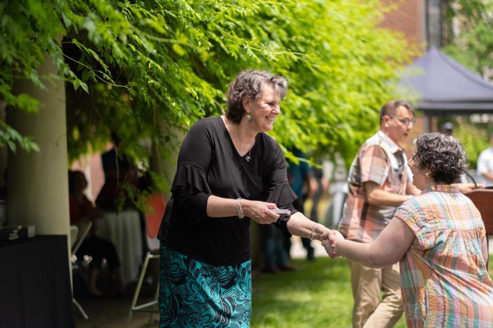 Amanda Chudnow shakes hands with Kim Cassidy at Staff Picnic