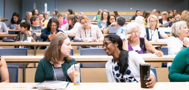 Volunteers in a classroom setting talking with each other