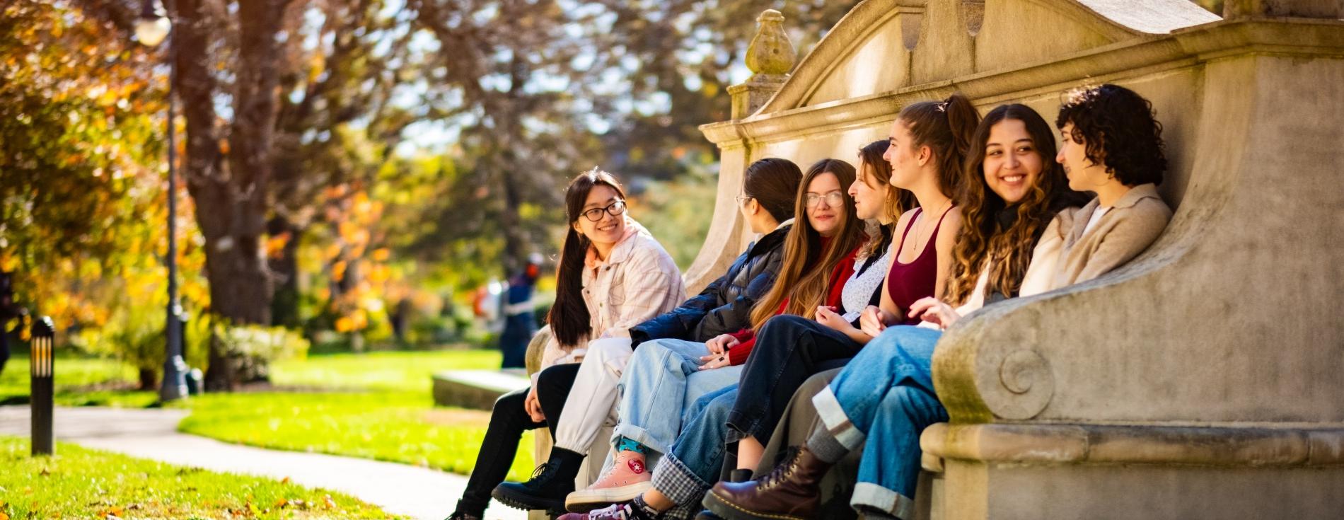 students-sitting-moon-bench