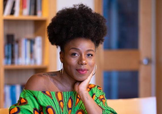 Chanelle Wilson seated at a table with a book